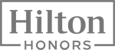 The image shows the logo for "Hilton Honors," the rewards program of the Hilton hotel chain, in gray text within a rectangular border.